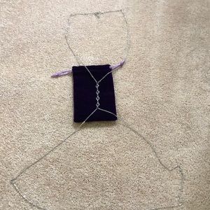 Silver drop body chain.